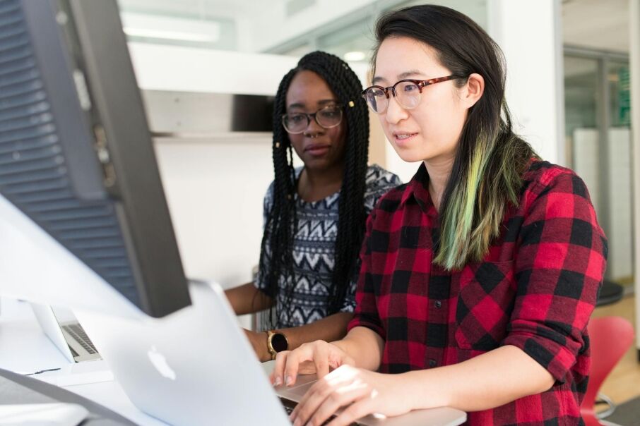 Woman using Macbook for writing